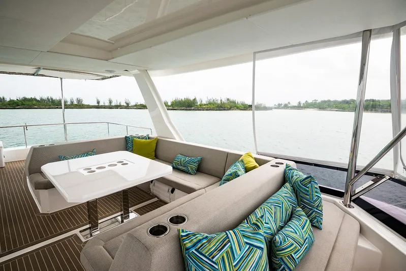 Lollypop Yacht Photos Pics Luxurious 2022 Leopard 53 Powercat yacht interior with stylish seating and scenic water view.