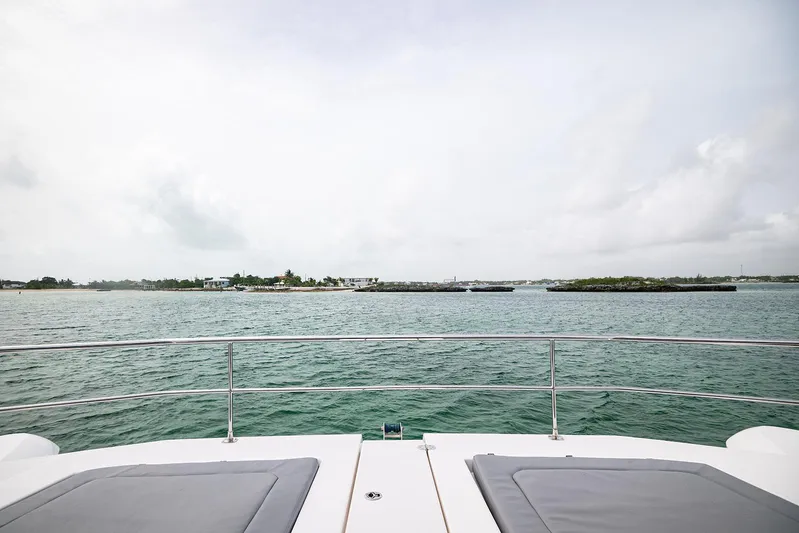 Lollypop Yacht Photos Pics Leopard 53 Powercat 2022 yacht deck view overlooking serene ocean and distant shoreline.