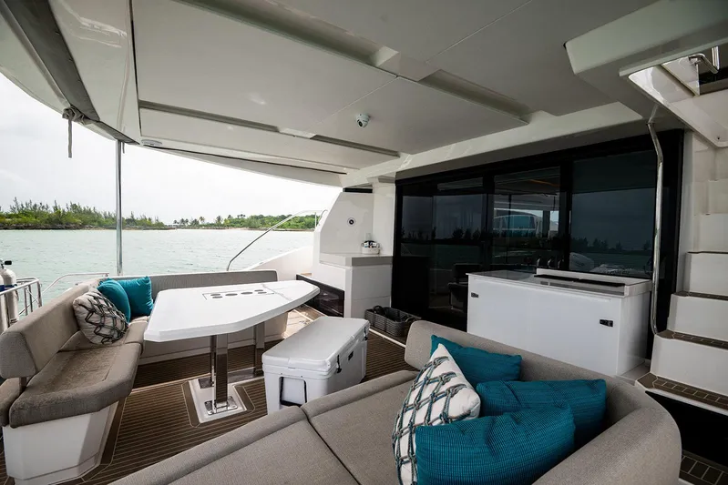 Lollypop Yacht Photos Pics Luxurious 2022 Leopard 53 Powercat yacht interior with elegant seating and scenic water view.