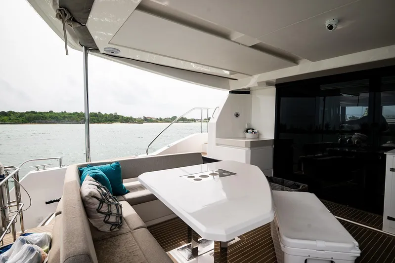 Lollypop Yacht Photos Pics Luxurious 2022 Leopard 53 Powercat yacht interior with elegant seating and scenic water view.