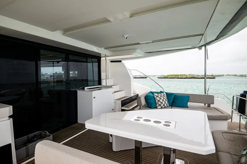 Lollypop Yacht Photos Pics Luxurious 2022 Leopard 53 Powercat yacht deck with seating, table, and ocean view.