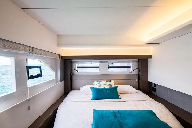 Lollypop Yacht Photos Pics Luxurious bedroom interior of 2022 Leopard 53 Powercat yacht with ocean view windows.