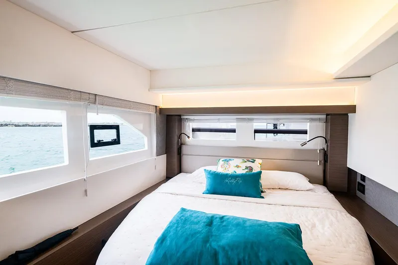 Lollypop Yacht Photos Pics Luxurious bedroom interior of 2022 Leopard 53 Powercat yacht with ocean view windows.