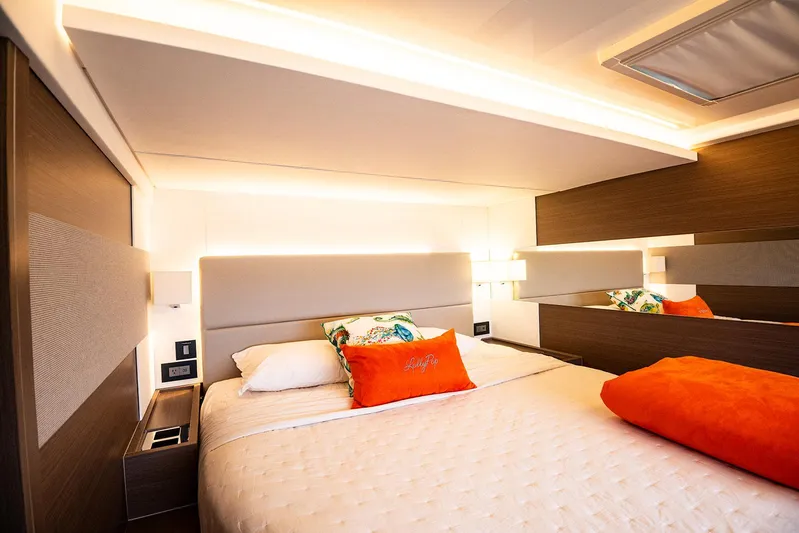 Lollypop Yacht Photos Pics Luxurious bedroom interior of 2022 Leopard 53 Powercat yacht with modern design and vibrant accents.