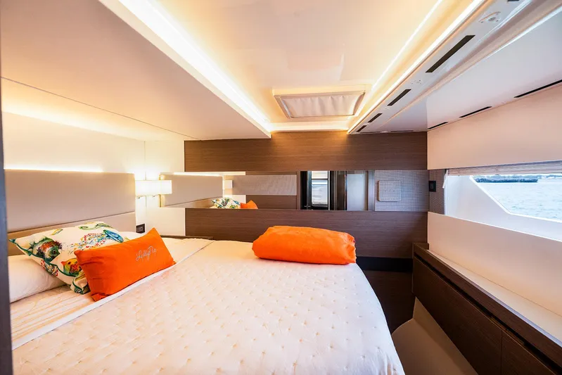 Lollypop Yacht Photos Pics Luxurious bedroom interior of 2022 Leopard 53 Powercat yacht with modern design and ocean view.