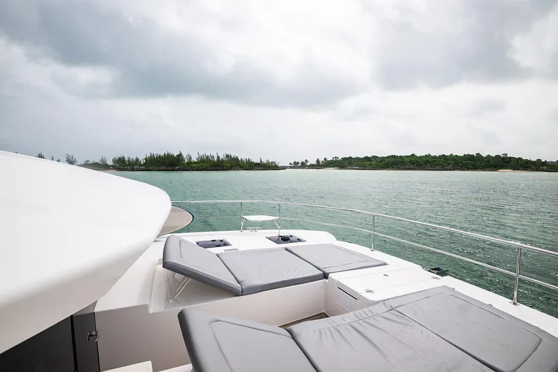 Lollypop Yacht Photos Pics Leopard 53 Powercat 2022 yacht with sun loungers, ocean view, and distant island.