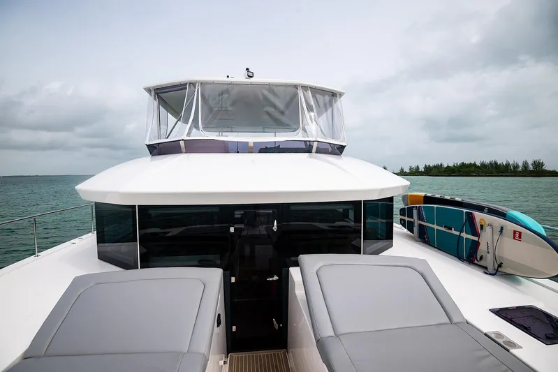 Lollypop Yacht Photos Pics Leopard 53 Powercat 2022 yacht with paddleboards, cruising on a calm sea.