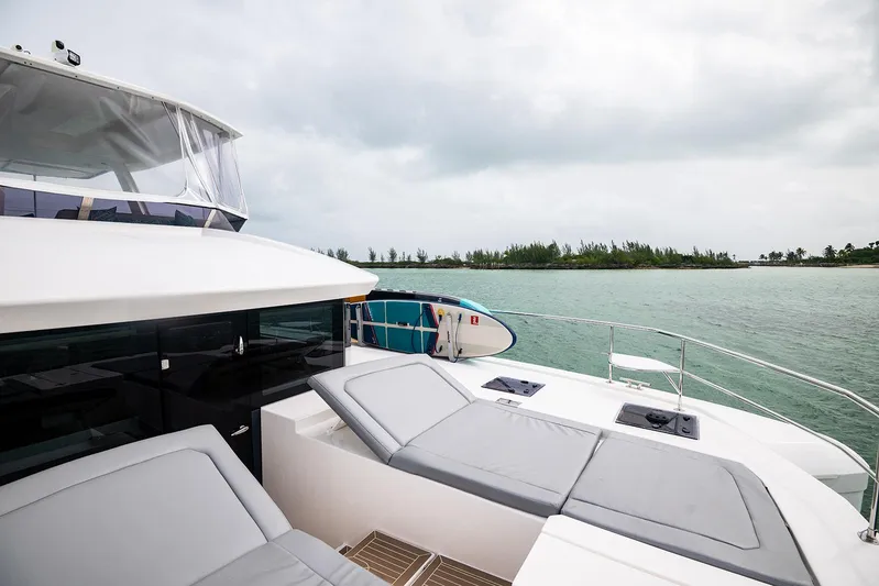 Lollypop Yacht Photos Pics Leopard 53 Powercat 2022 yacht with sun loungers, ocean view, and paddleboard.