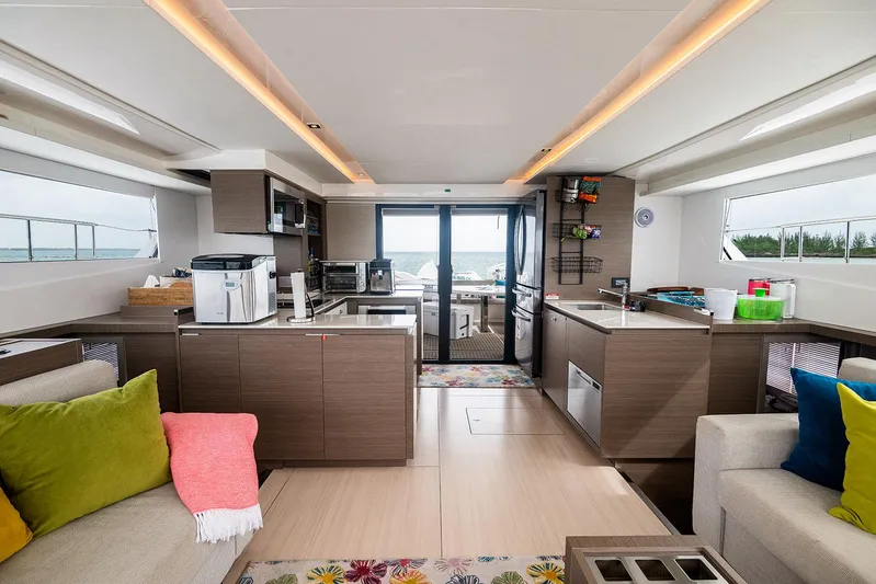 Lollypop Yacht Photos Pics Luxurious interior of 2022 Leopard 53 Powercat yacht with modern kitchen and seating area.