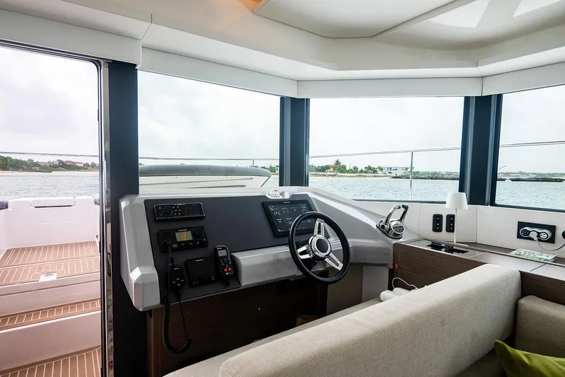 Lollypop Yacht Photos Pics Interior view of 2022 Leopard 53 Powercat yacht helm with modern controls and ocean backdrop.