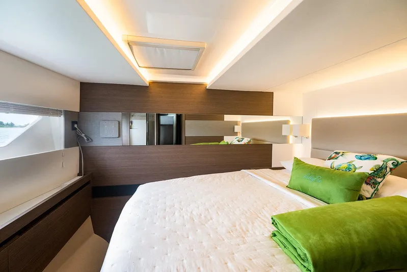 Lollypop Yacht Photos Pics Luxurious bedroom interior of 2022 Leopard 53 Powercat with modern design and green accents.