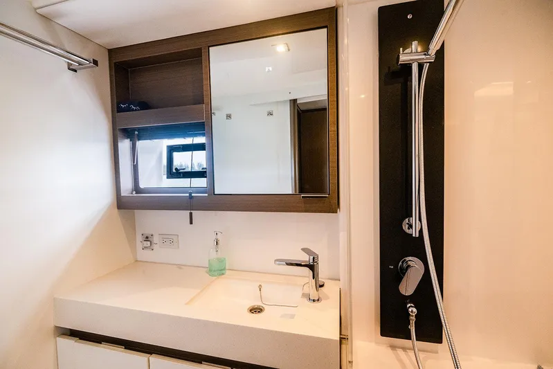 Lollypop Yacht Photos Pics Modern bathroom on 2022 Leopard 53 Powercat yacht with sleek fixtures and mirror.