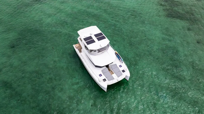 Lollypop Yacht Photos Pics 2022 Leopard 53 Powercat yacht on clear turquoise water, aerial view.