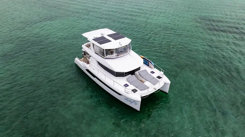 Lollypop Yacht Photos Pics 2022 Leopard 53 Powercat yacht on clear turquoise water, aerial view.