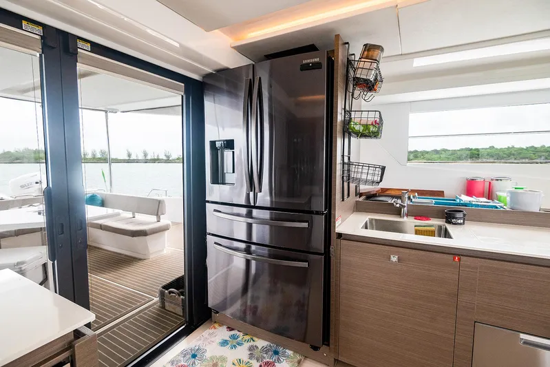 Lollypop Yacht Photos Pics Modern kitchen on 2022 Leopard 53 Powercat with stainless steel fridge and outdoor view.