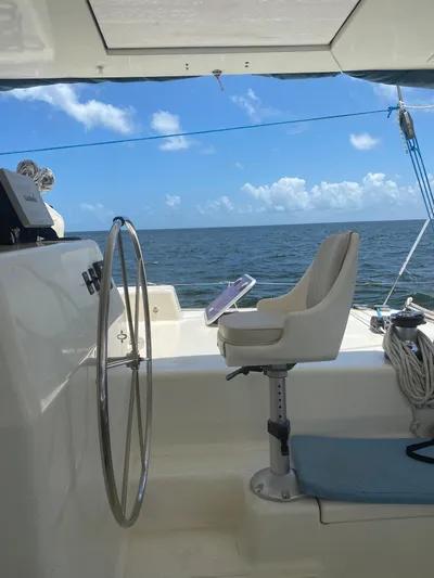 Swish Yacht Photos Pics 1996 Voyage Mayotte sailboat helm with ocean view and blue sky.