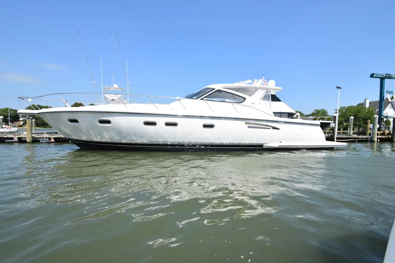 Current Situation Yacht Photos Pics 2001 Tiara Yachts 52 Sport Yacht on calm water, docked at a marina.