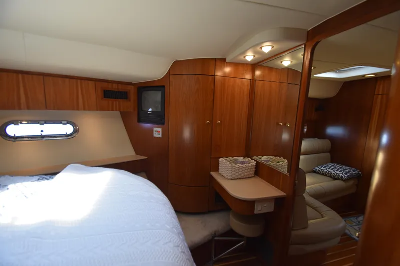 Current Situation Yacht Photos Pics Luxurious interior of 2001 Tiara Yachts 52 Sport Yacht with wood paneling and cozy seating.