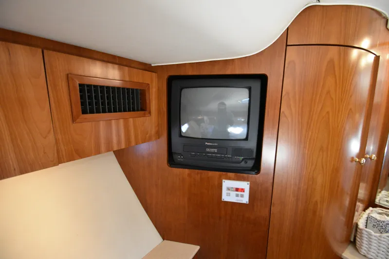 Current Situation Yacht Photos Pics 2001 Tiara Yachts 52 Sport Yacht interior with vintage TV and wooden cabinetry.