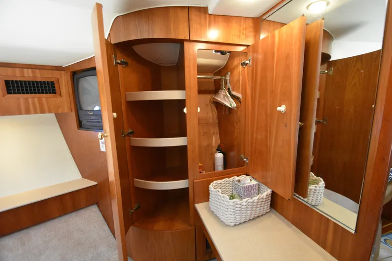 Current Situation Yacht Photos Pics Interior of 2001 Tiara Yachts 52 Sport Yacht with wooden cabinetry and storage space.