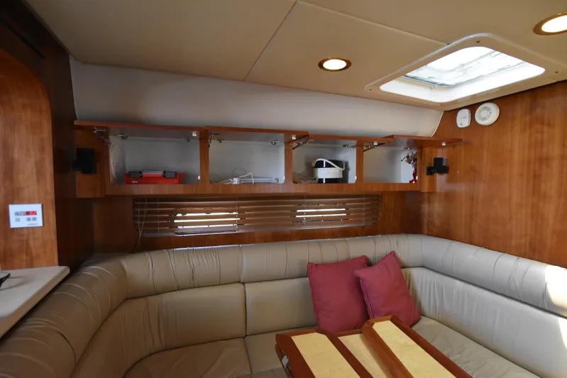 Current Situation Yacht Photos Pics Interior of 2001 Tiara Yachts 52 Sport Yacht with beige seating and wooden cabinetry.