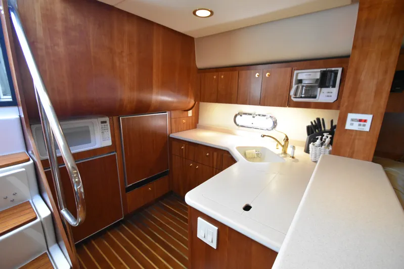 Current Situation Yacht Photos Pics Luxurious kitchen interior of 2001 Tiara Yachts 52 Sport Yacht with wood cabinetry.