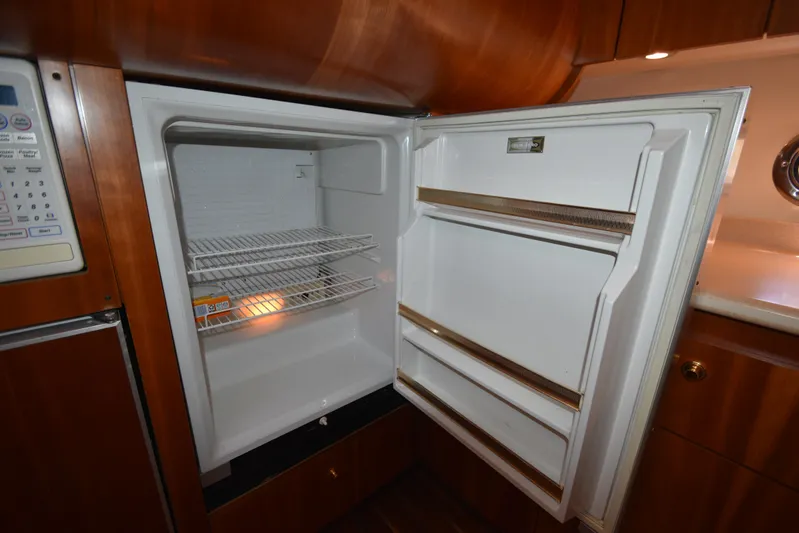 Current Situation Yacht Photos Pics Open refrigerator inside 2001 Tiara Yachts 52 Sport Yacht, showcasing interior shelves and door compartments.