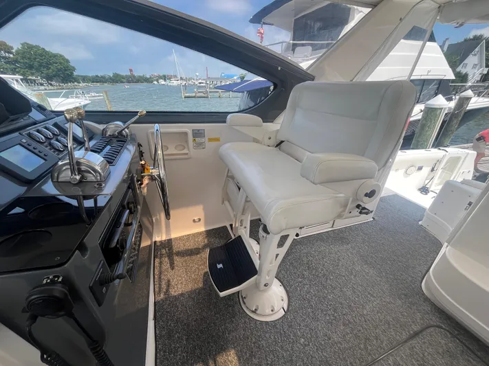Current Situation Yacht Photos Pics Helm of 2001 Tiara Yachts 52 Sport Yacht with white captain's chair and control panel.