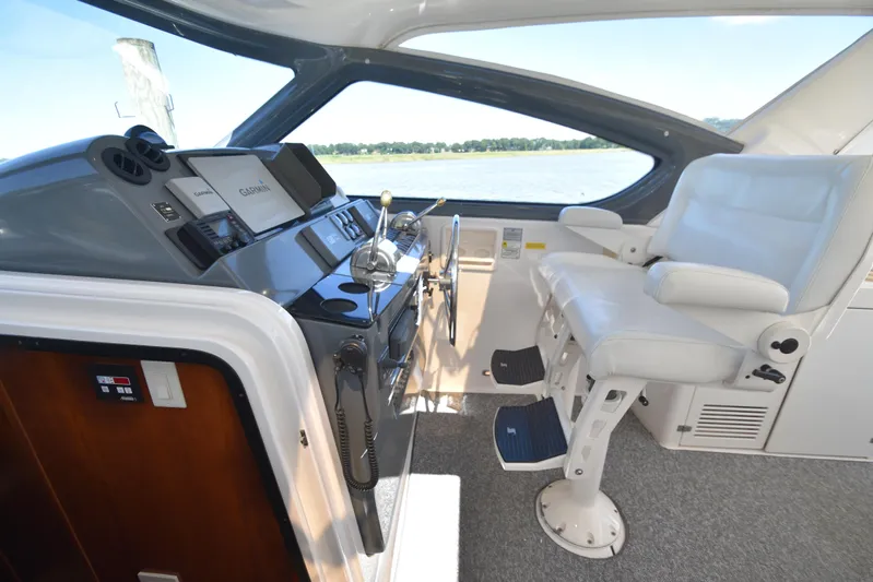 Current Situation Yacht Photos Pics Helm of 2001 Tiara Yachts 52 Sport Yacht with white captain's chair and navigation equipment.