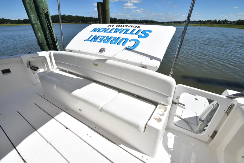 Current Situation Yacht Photos Pics 2001 Tiara Yachts 52 Sport Yacht with white seating, docked by calm waters.