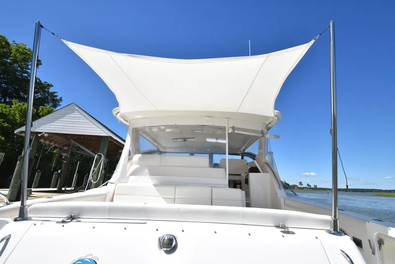 Current Situation Yacht Photos Pics 2001 Tiara Yachts 52 Sport Yacht with white canopy, docked under clear blue sky.