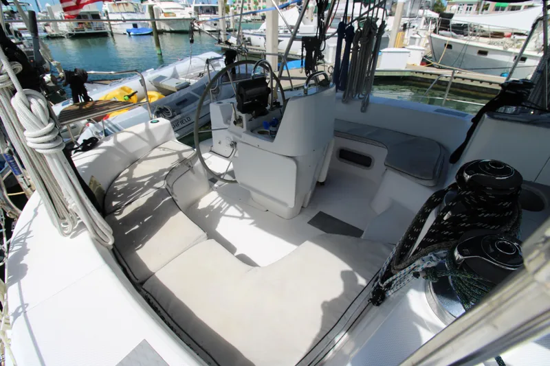 Medicinal Yacht Photos Pics Cockpit of 2002 Hunter 410 sailboat with seating and steering wheel, docked at marina.