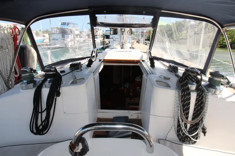 Medicinal Yacht Photos Pics 2002 Hunter 410 sailboat cockpit with ropes and steering wheel in marina setting.