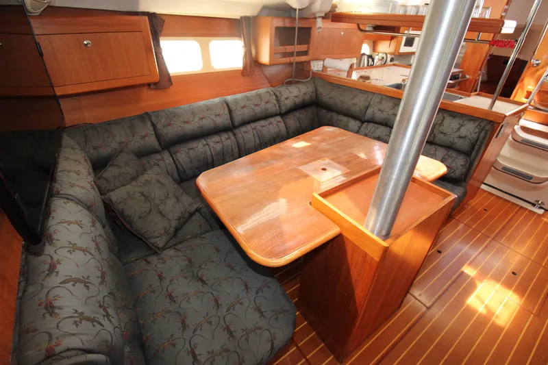 Medicinal Yacht Photos Pics Spacious interior of 2002 Hunter 410 sailboat with cozy seating and wooden table.