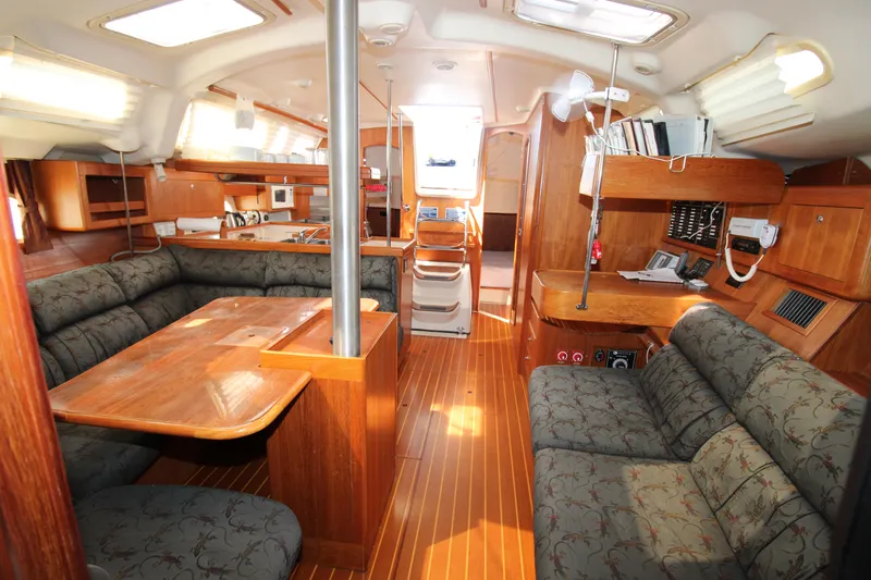 Medicinal Yacht Photos Pics Interior of 2002 Hunter 410 sailboat with wood finish and cozy seating area.
