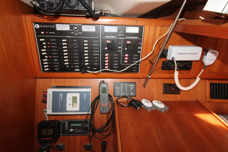Medicinal Yacht Photos Pics Electrical control panel in a 2002 Hunter 410 sailboat cabin, featuring various instruments and switches.
