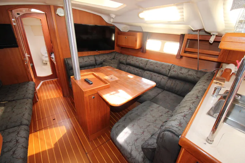 Medicinal Yacht Photos Pics Spacious interior of 2002 Hunter 410 sailboat with cozy seating and wooden finishes.