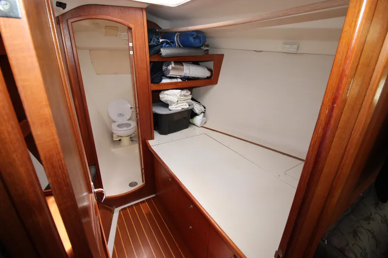 Medicinal Yacht Photos Pics Interior of 2002 Hunter 410 sailboat with wooden cabinetry and compact bathroom.