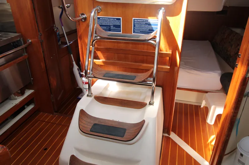 Medicinal Yacht Photos Pics Interior of 2002 Hunter 410 sailboat with wooden steps and cozy cabin area.