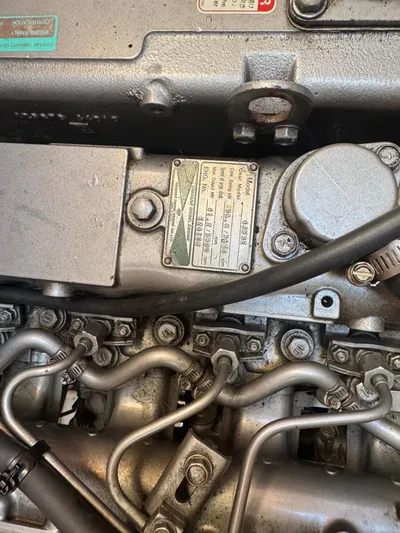 Medicinal Yacht Photos Pics Close-up of a 2002 Hunter 410 engine with visible metal components and labels.