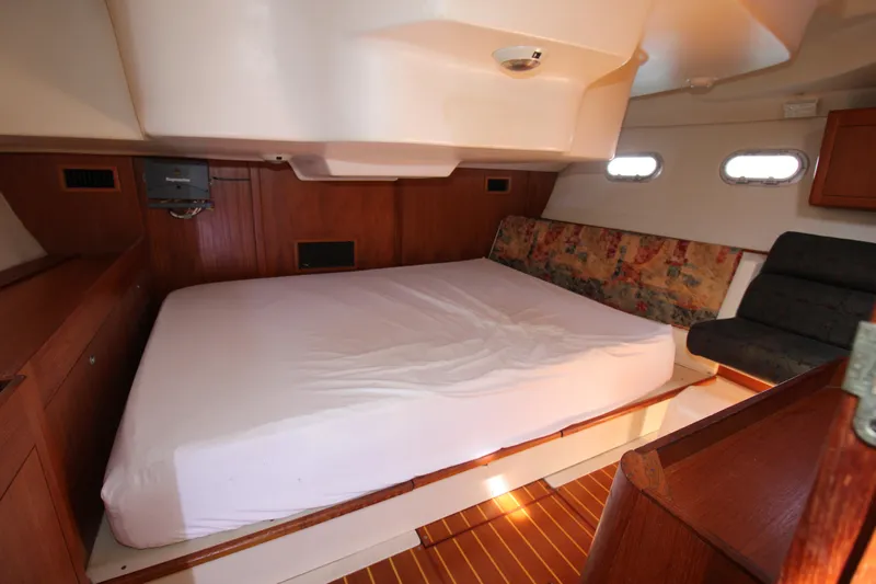 Medicinal Yacht Photos Pics Interior of 2002 Hunter 410 yacht with spacious bed and wooden accents.