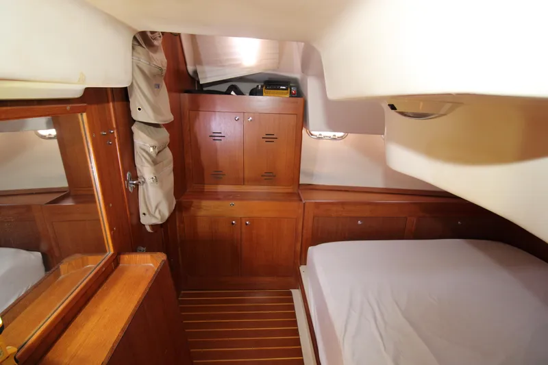 Medicinal Yacht Photos Pics Cozy cabin interior of 2002 Hunter 410 sailboat with wooden furnishings and bed.