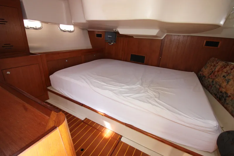 Medicinal Yacht Photos Pics Interior cabin of 2002 Hunter 410 yacht with wooden finish and bed.