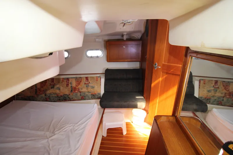 Medicinal Yacht Photos Pics Interior of 2002 Hunter 410 sailboat cabin with bed, seating, and wooden accents.