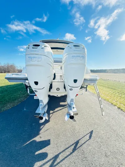 The Good Stuff Yacht Photos Pics 2023 Sea Ray SLX 310 OB boat with dual outboard engines on a sunny day.