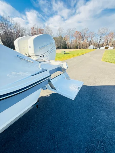 The Good Stuff Yacht Photos Pics 2023 Sea Ray SLX 310 OB boat with dual outboard motors on a sunny day.