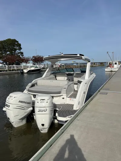 The Good Stuff Yacht Photos Pics 2023 Sea Ray SLX 310 OB boat docked with twin Mercury outboard engines.