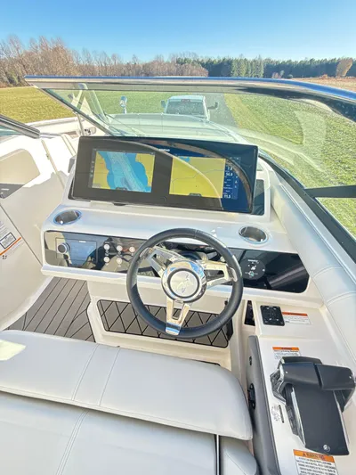 The Good Stuff Yacht Photos Pics 2023 Sea Ray SLX 310 OB helm with dual displays and modern steering wheel.