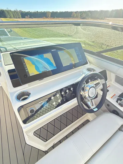 The Good Stuff Yacht Photos Pics 2023 Sea Ray SLX 310 OB boat dashboard with dual navigation screens and modern steering wheel.