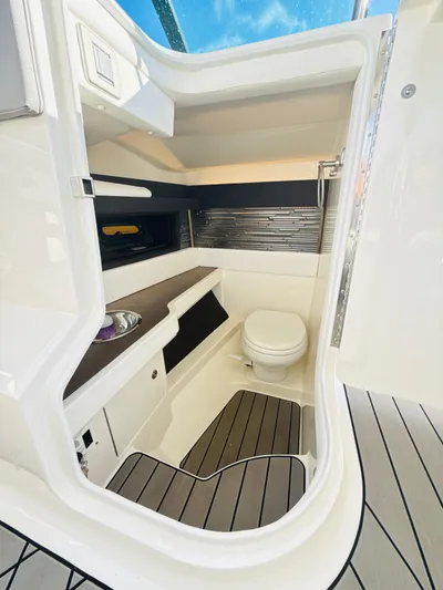 The Good Stuff Yacht Photos Pics 2023 Sea Ray SLX 310 OB boat interior with modern bathroom amenities.